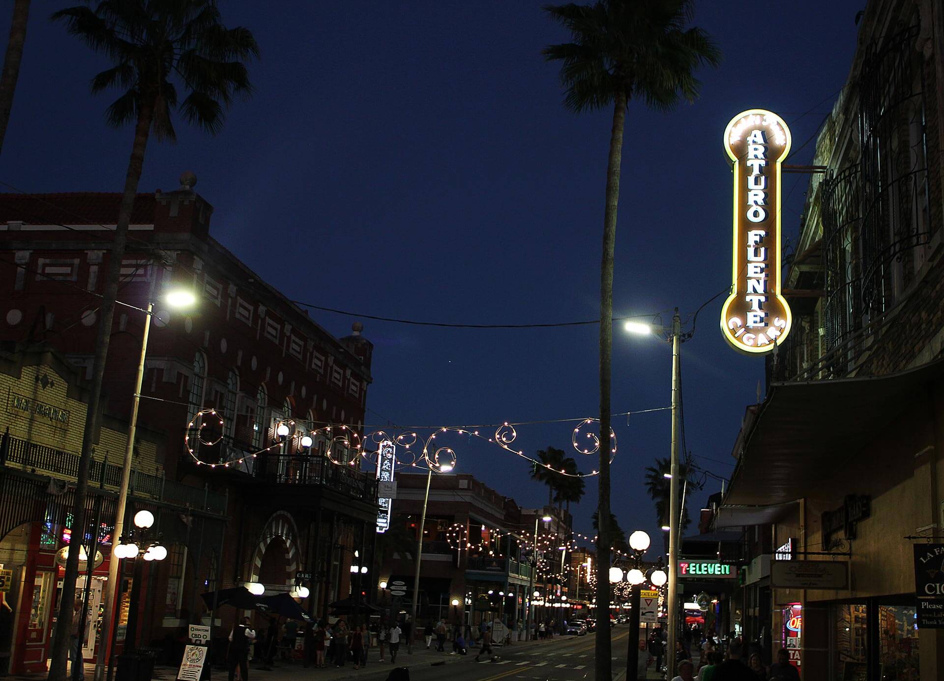 Ybor City, 7th Ave at night. Arturo Fuente sign alight. The entrance to King Corona Cigars.